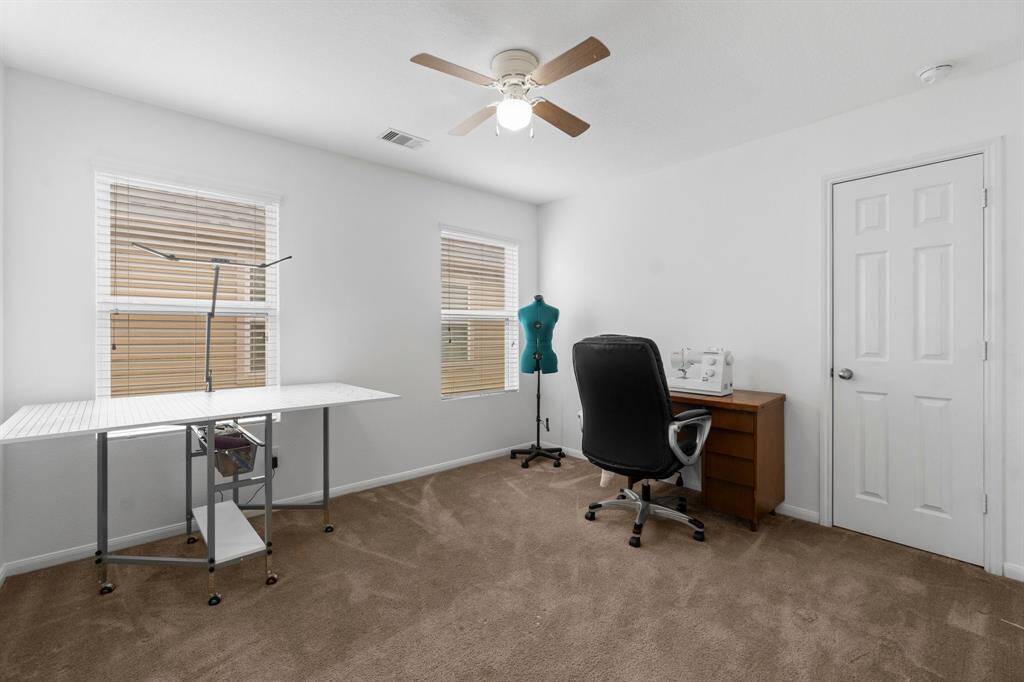 Currently used as a sewing room this secondary bedroom can be used for a plethora of activities