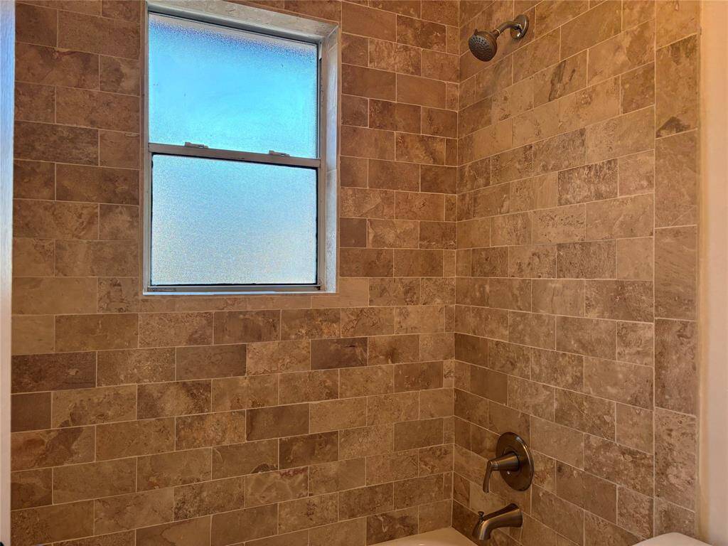 Updated tile surround in hall bath. Conveniently located between the secondary bedrooms.