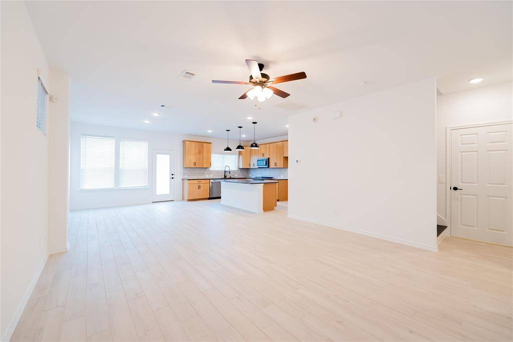 Bright open-concept living area with modern kitchen.