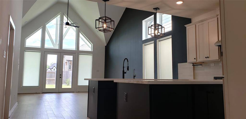 Another stunning perspective of the soaring cathedral ceilings, which flood the space with natural light and enhance the home's bright, airy ambiance.
