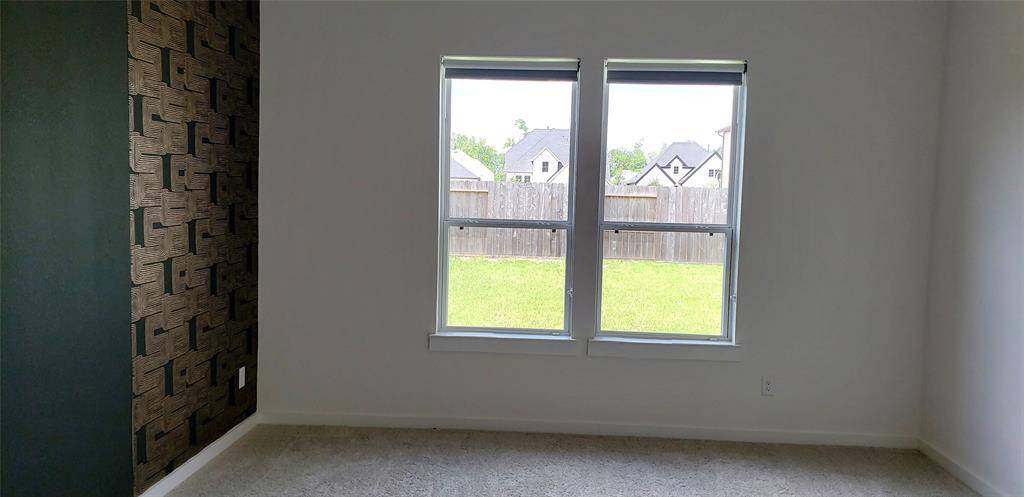 The primary bedroom offers serene views of the lush backyard, creating a peaceful retreat right at home.