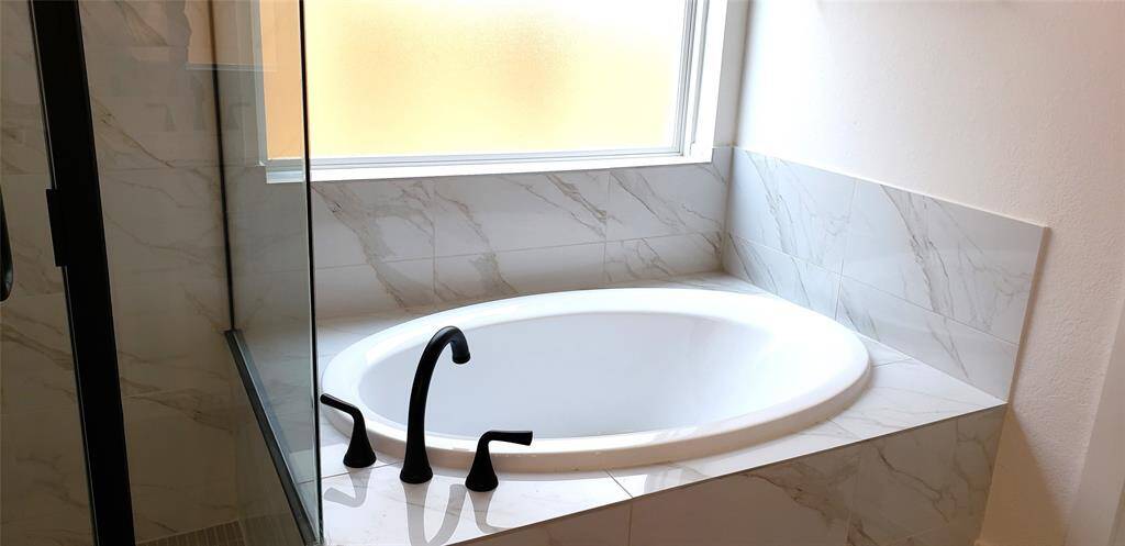 Unwind in the luxurious soaking tub—an ideal escape to relax and rejuvenate after a long day.