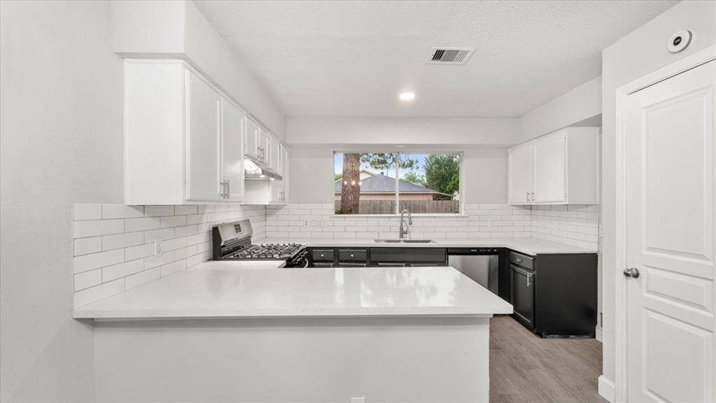 Open concept kitchen with bar area. New quartz counter tops installed, new stainless steel appliances. All new flooring installed.