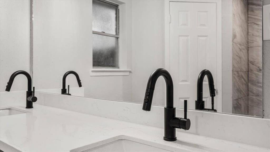 Primary bathroom stand up shower with "His" and "Hers" closets.