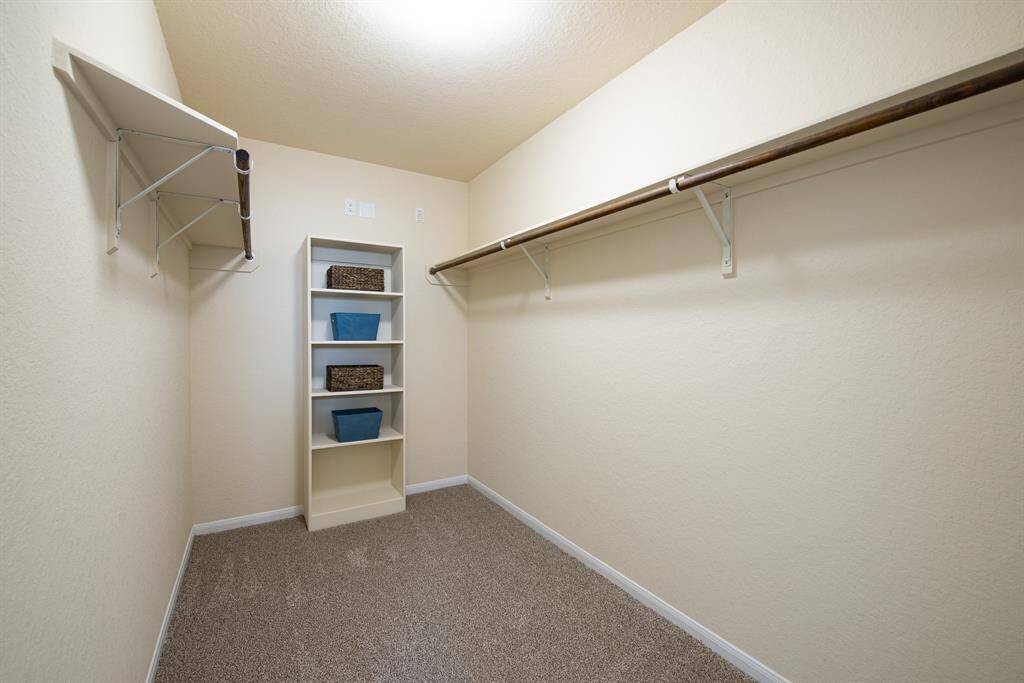 primary walk-in closet with built-in