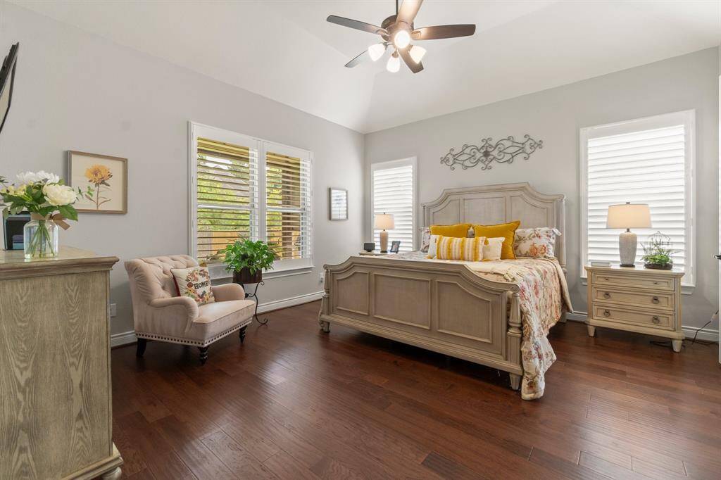 The primary suite includes a sitting area, patio access, and vaulted ceilings.