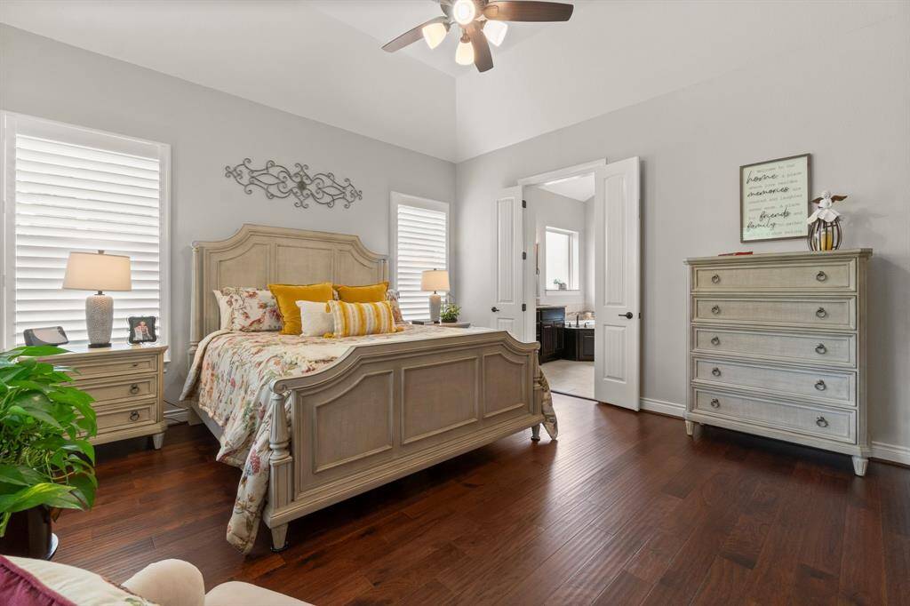 The primary suite includes a sitting area, patio access, and vaulted ceilings.