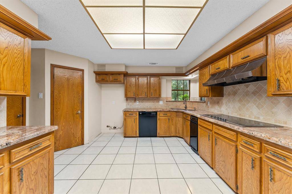 Kitchen with granite counters, double ovens and trash compactor