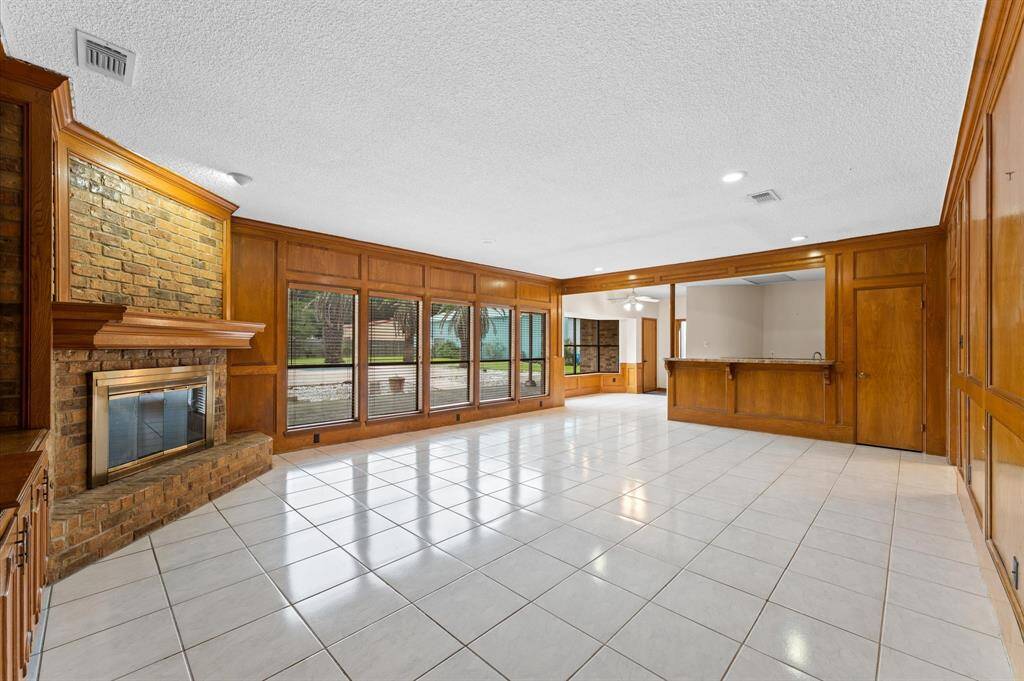 Living room with fireplace and view of pool