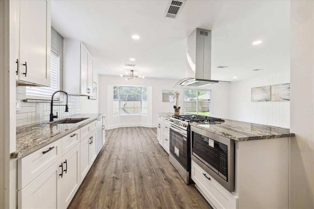 Additional features of the kitchen include recessed lighting, a pantry, and an open layout connecting seamlessly to the family room.