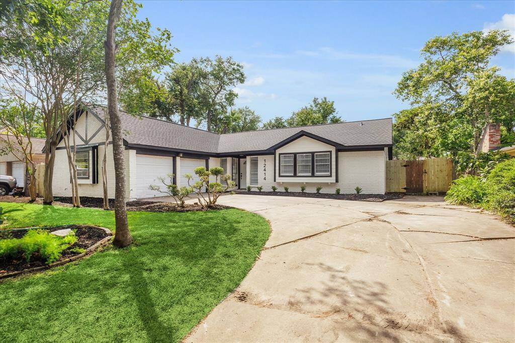 Freshly landscaped front yard with a double-wide driveway and spacious 2-car garage.
