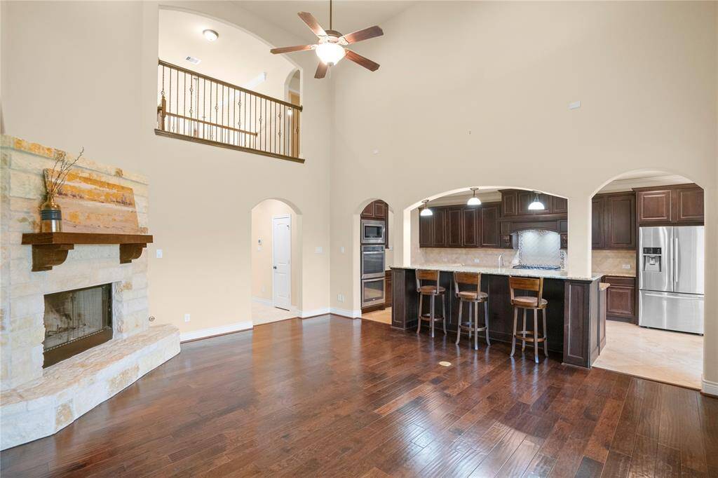 Large granite kitchen bar provides visiting with the chef while still being a part of the family room activities.