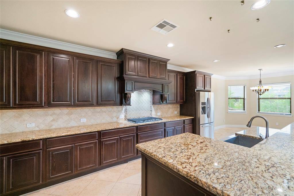 Look at all this granite counter space and beautiful backsplash! The chef in the family has quite the room to prepare.