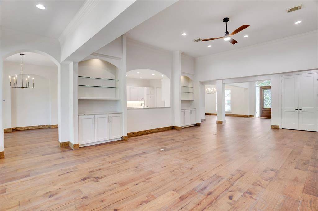 Extensive built-in cabinets and shelves on both sides of living room.