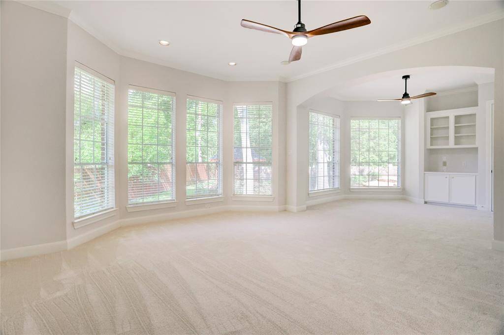 Master bedroom has wall of windows to back yard and sitting areas with built-ins.