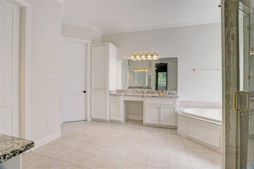 Master bathroom has two vanity areas with sinks.