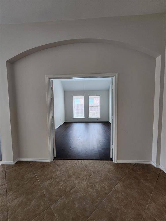 Home office/5th bedroom/gameroom complete with high ceilings, a ceiling fan, wood floors and French doors