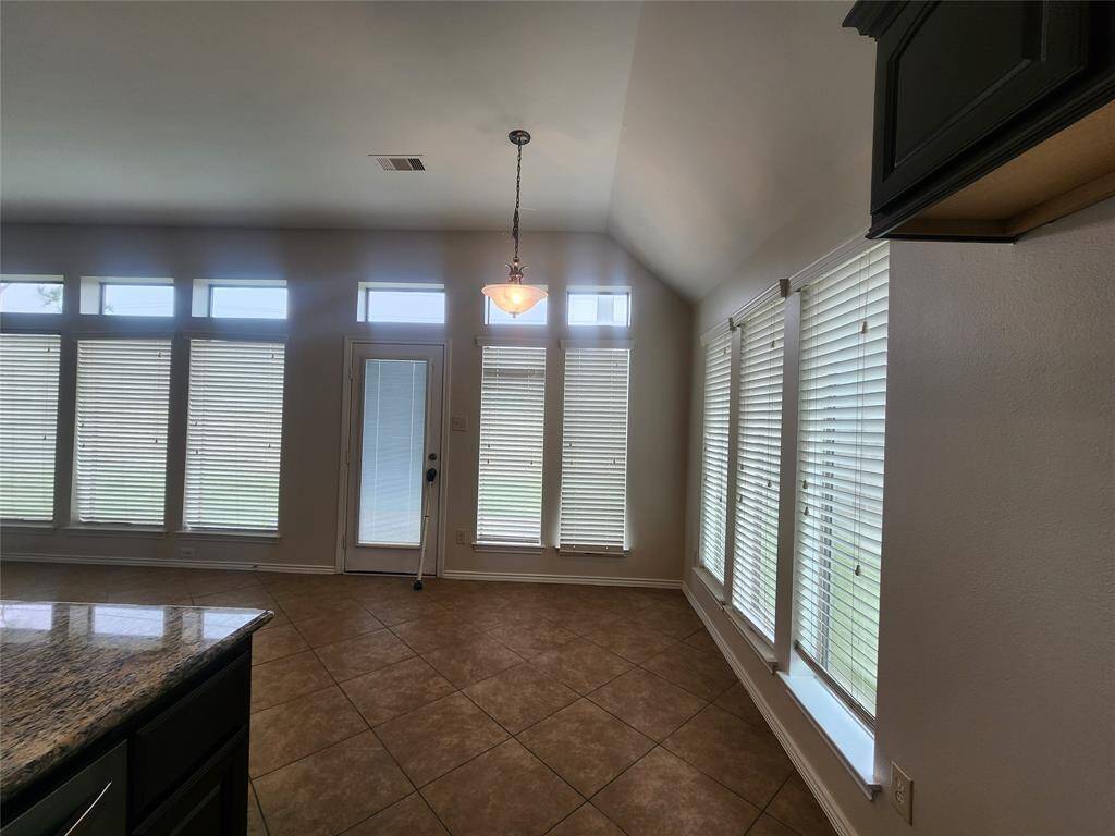 Home office/5th bedroom/game room complete with high ceilings, a ceiling fan, wood floors and French doors