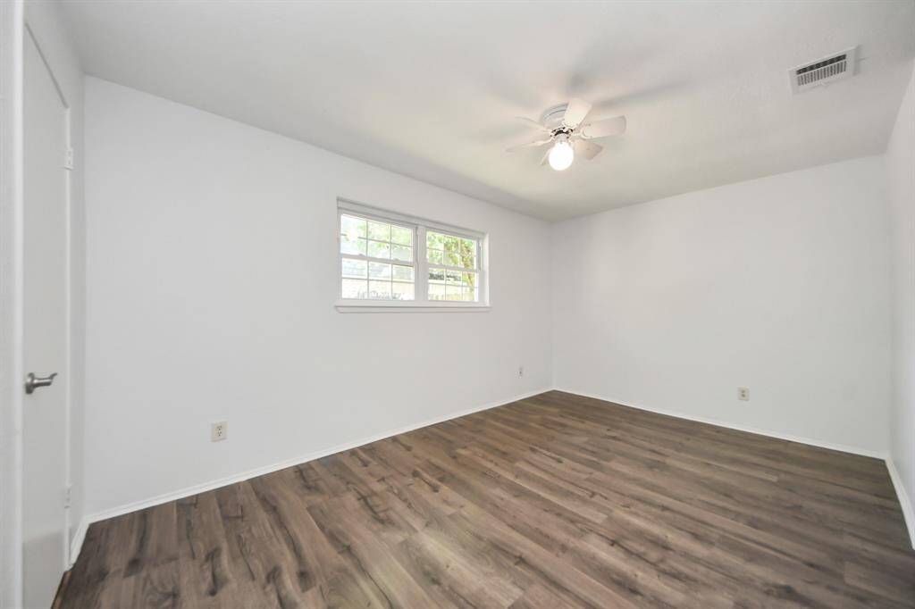 Bedroom 2 with brand new floors, newer windows, a ceiling fan and a spacious closet!