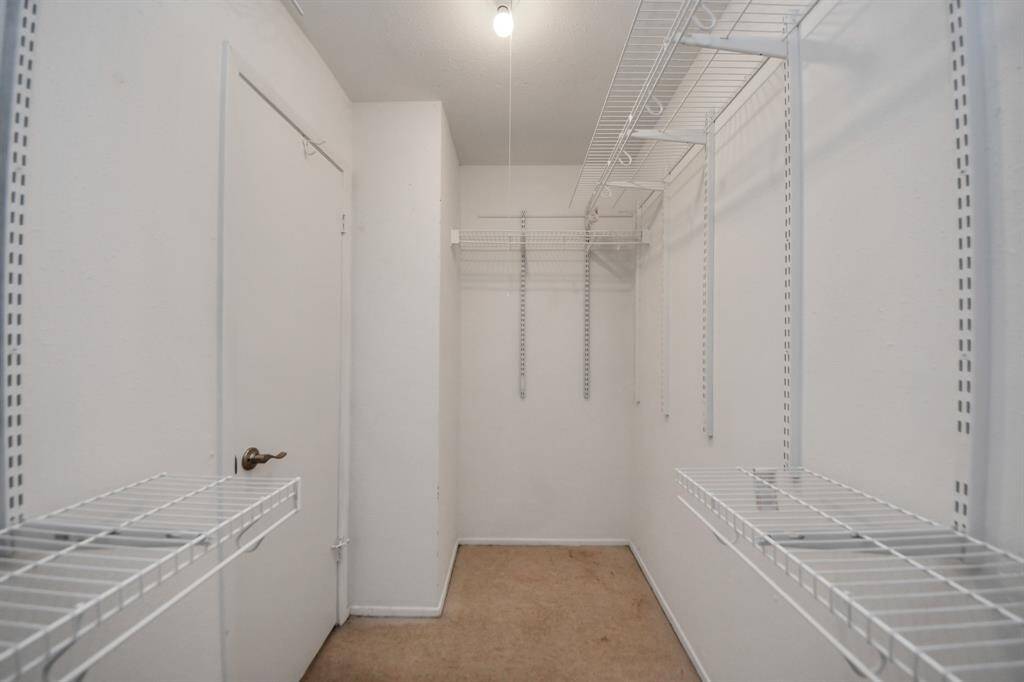 The primary suite offers a large walk-in closet with built in racks.