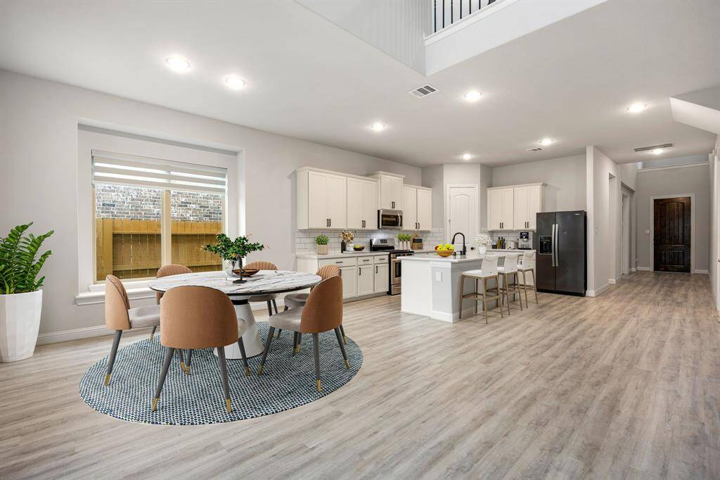 Enjoy the perfect blend of style and functionality in this open kitchen and breakfast area. With seamless flow, it’s ideal for casual dining, morning coffee, or gathering with friends and family. Bright cabinetry, ample counter space, and a central island create a warm, inviting atmosphere where every meal feels special.