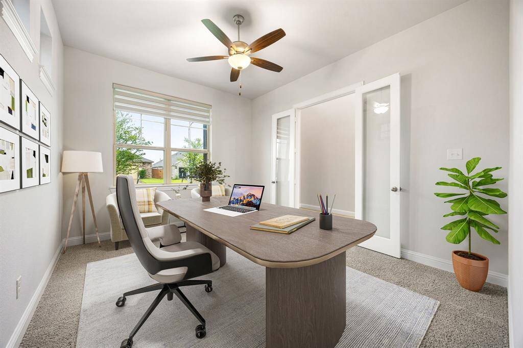 Nestled away quietly in the front of the home is the handsome and grand home office. Featuring French doors, high ceilings, ceiling fan, neutral paint, plush carpet flooring, and large windows with privacy blinds.