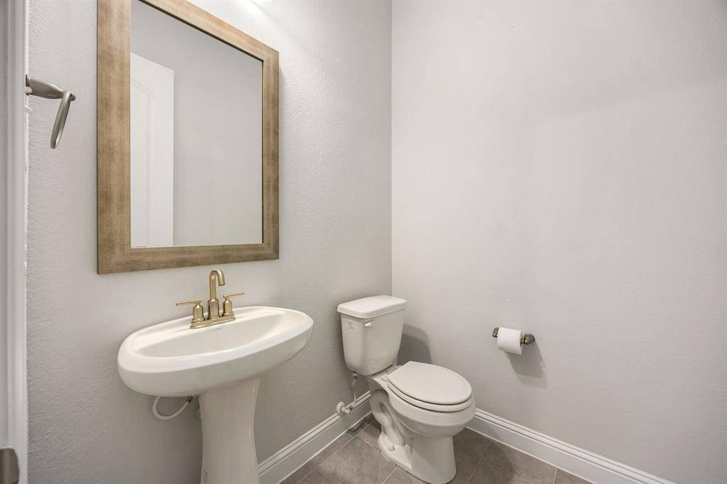 Convenient and stylish, this well-appointed half bath offers modern fixtures and tasteful finishes—perfect for guests and everyday ease.