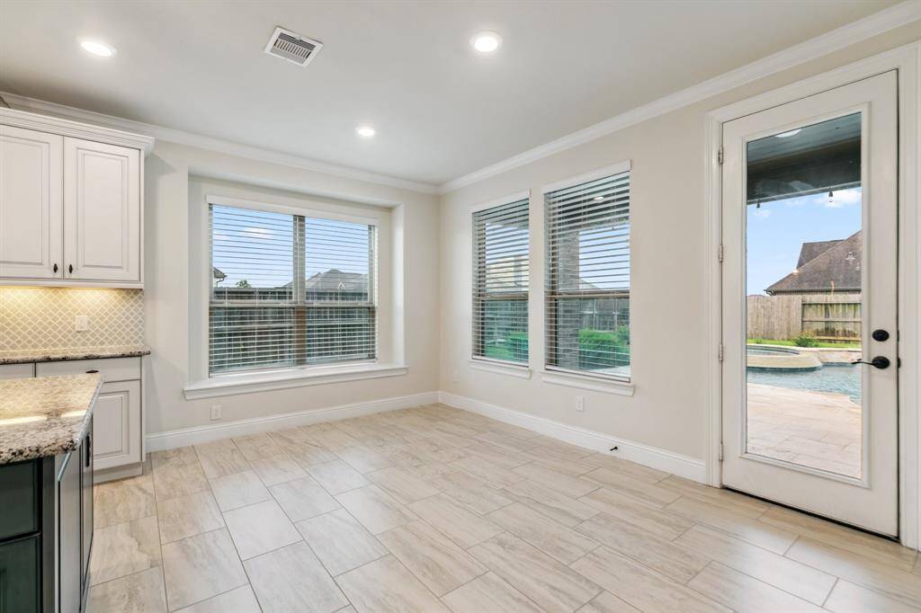 Large breakfast area with view of the pool and patio.
