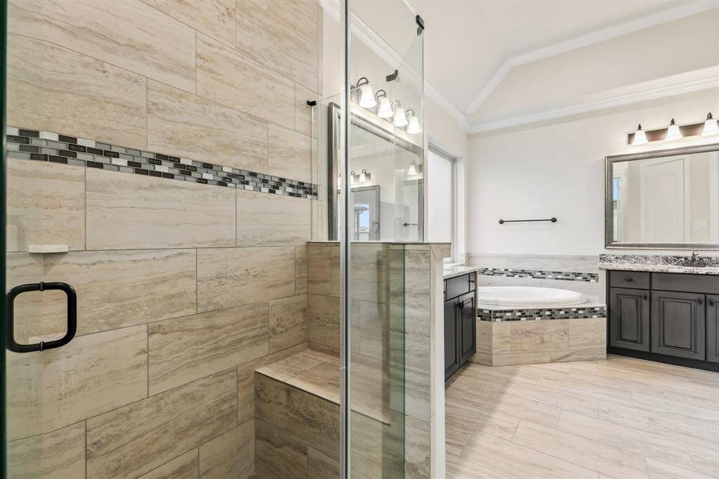 Primary bath offers a separate walk-in shower with bench seat.