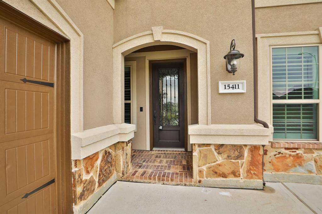 Iron Front Door with covered porch entry.