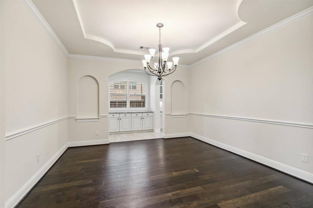 Elegant dining room with decorative tray ceiling.