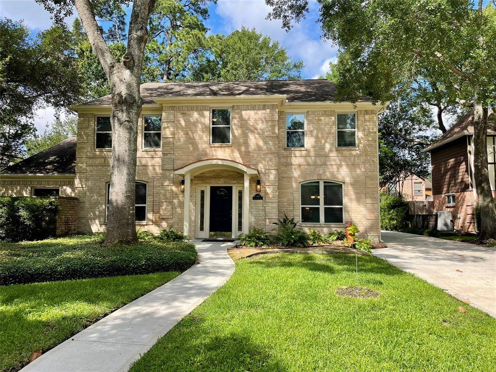 A warm welcome awaits with a stunning copper curved awning over the entry, a stylish address plaque, elegant sconces, upgraded windows, and thoughtfully designed landscaping that enhances curb appeal.