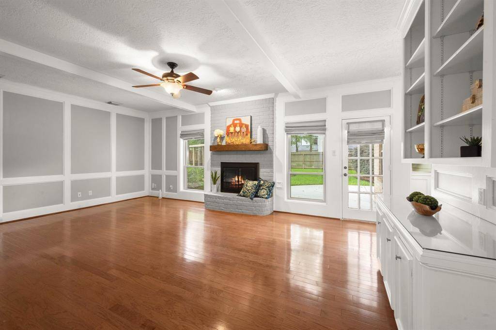 Spacious family room features built-in cabinets and shelving—perfect for showcasing your treasured collections and creating a cozy, organized living space.