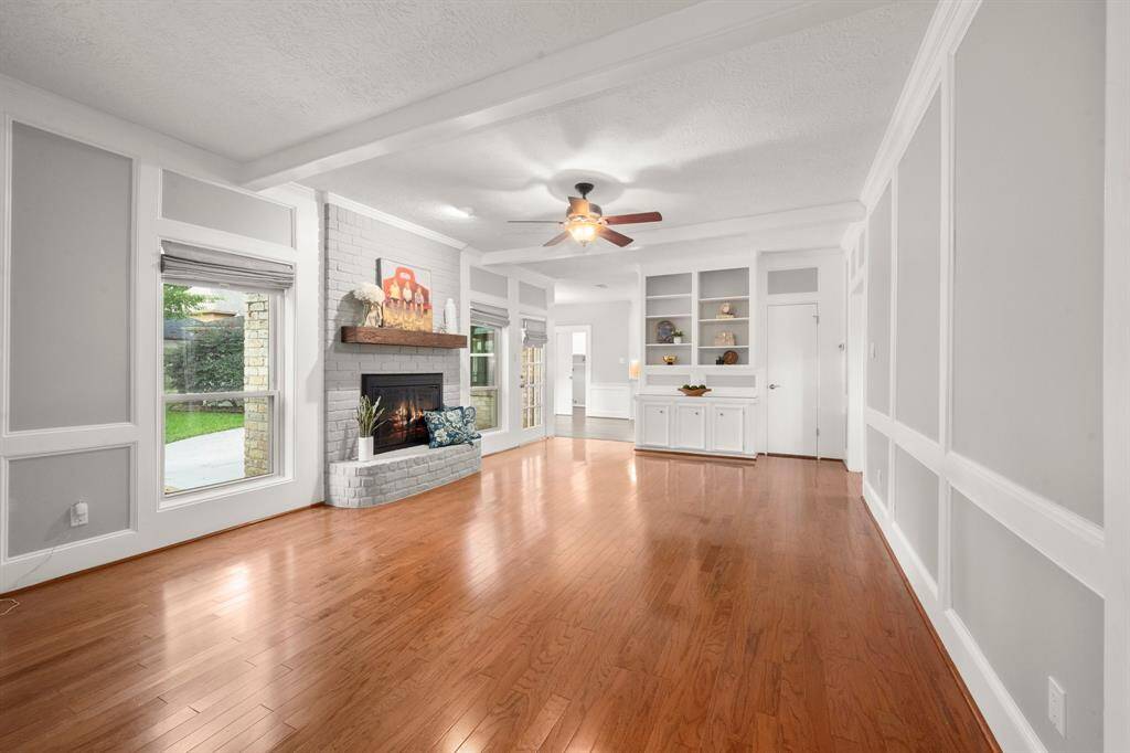 Luxurious walk-in shower features seamless glass, a soothing pebble floor, built-in seat, a convenient shampoo nook, and floor-to-ceiling tile for a spa-like experience.
