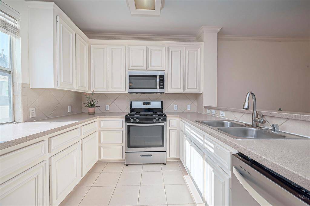 This kitchen boasts generous counter space and plentiful cabinets.
