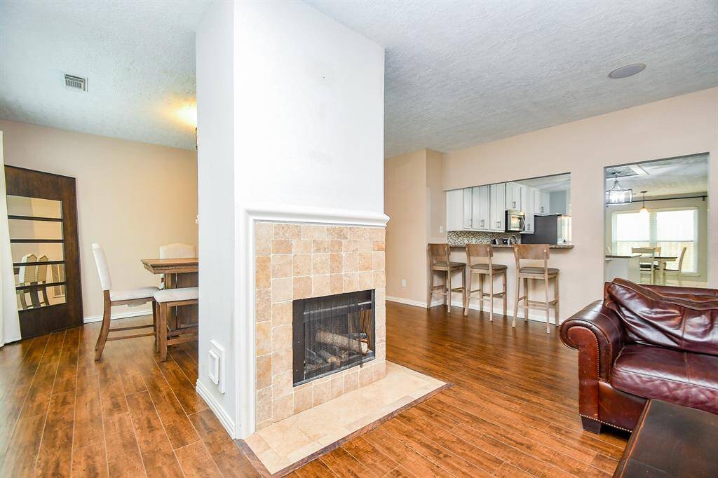 The Wood Burning Fireplace is the Focal Point of Open Concept Living Area.