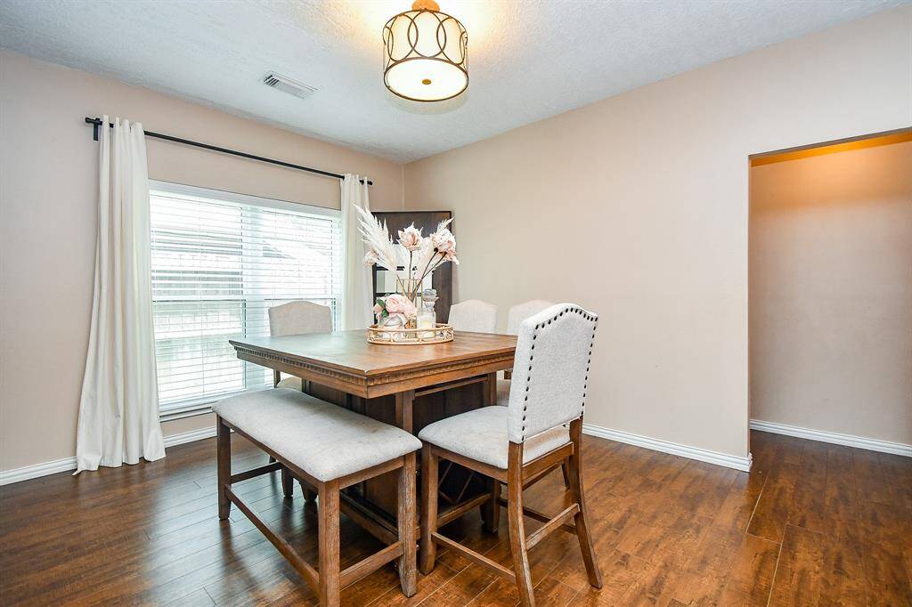 The formal dining room is perfect for hosting special dinners, offering a warm and elegant setting.