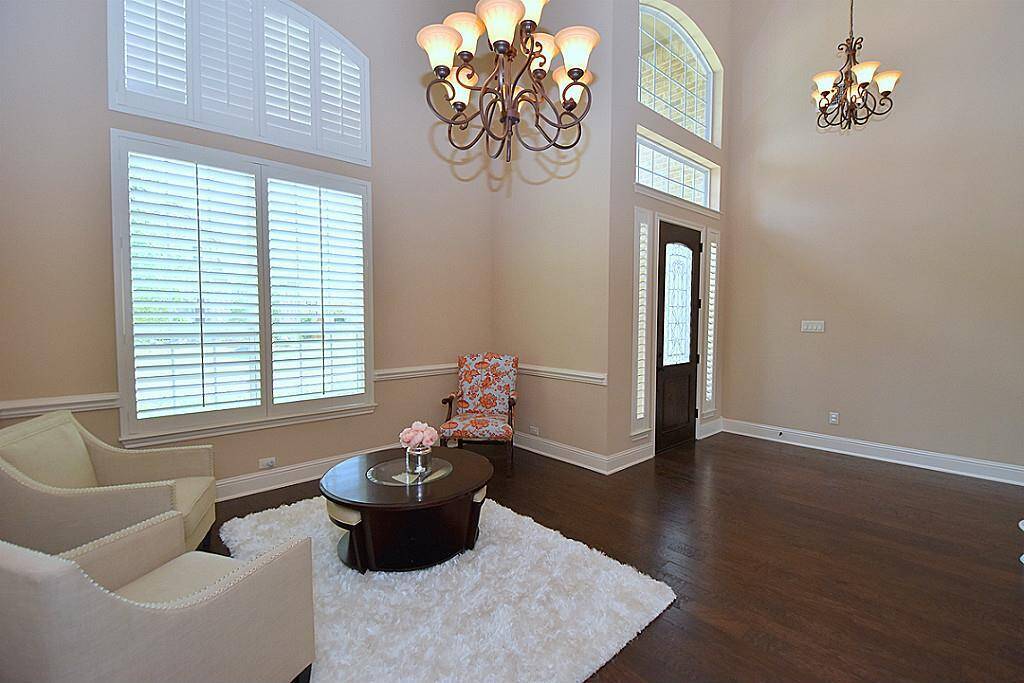 Dramatic 2 story entry with 8 solid wood door & wood flooring!