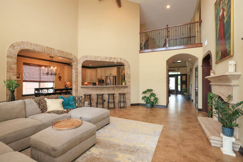 Cast stone gas log fireplace flanked by custom stained built ins