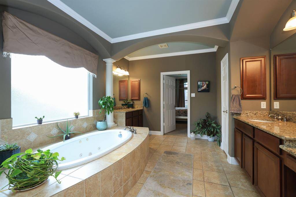 Double vanities with one offering a make up station with pull out drawers.