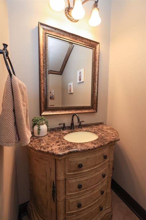 Newer vanity with marble top and oil rubbed bronze faucet. Decorator mirror