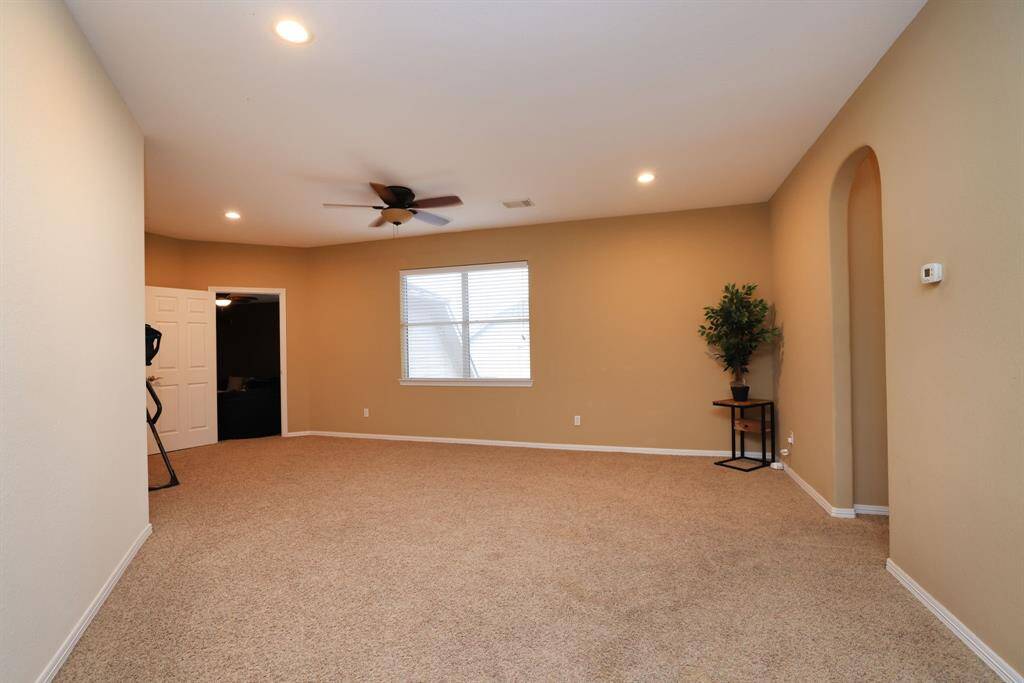 Game room located on second floor with solid walls. No noise to the first floor. To the right is a hallway to full bath, linen closet and two bedrooms. Walking forward is the media room with storage closet.