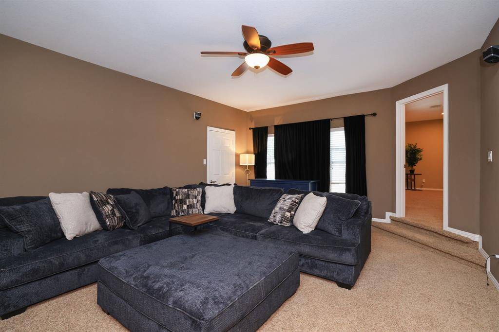 Additional view of media room. Windows with black out curtians. walk in storage closet.