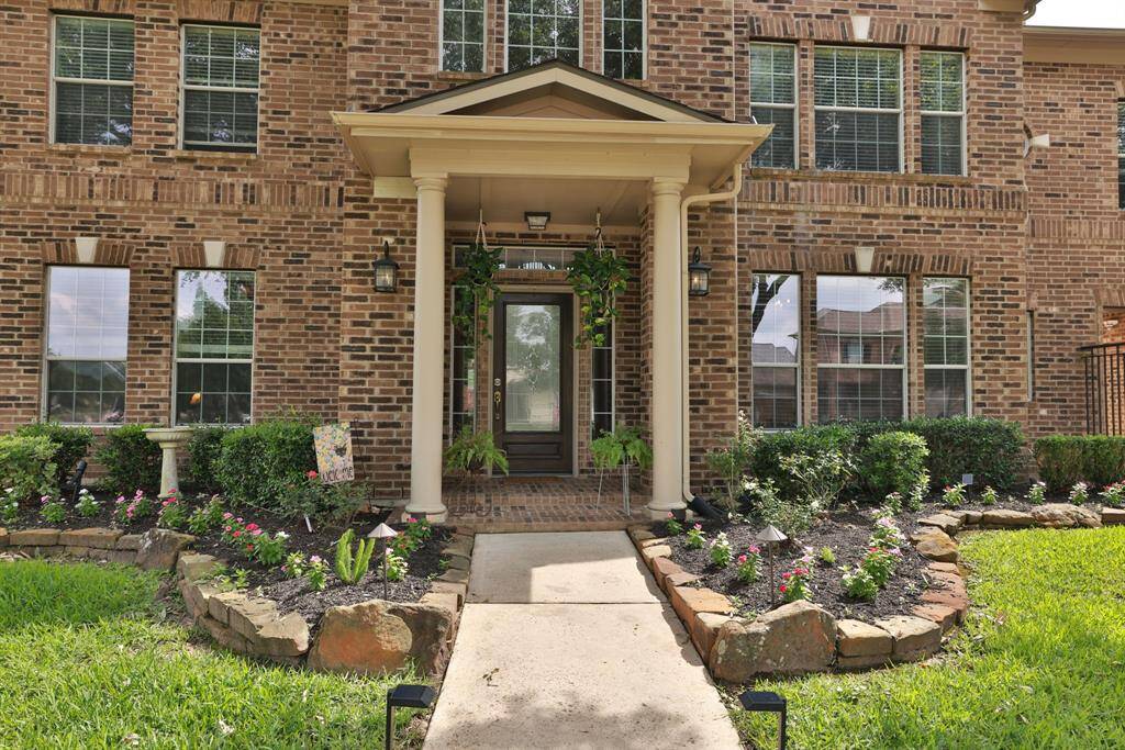 Landscaped freshed with flowers and mulch. Powerwashed walkway. Sprinklers.