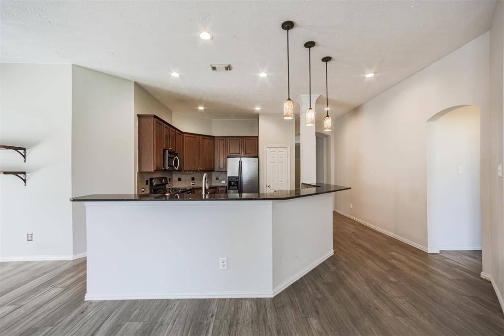 Modern kitchen with a stylish breakfast bar and sleek granite countertops.