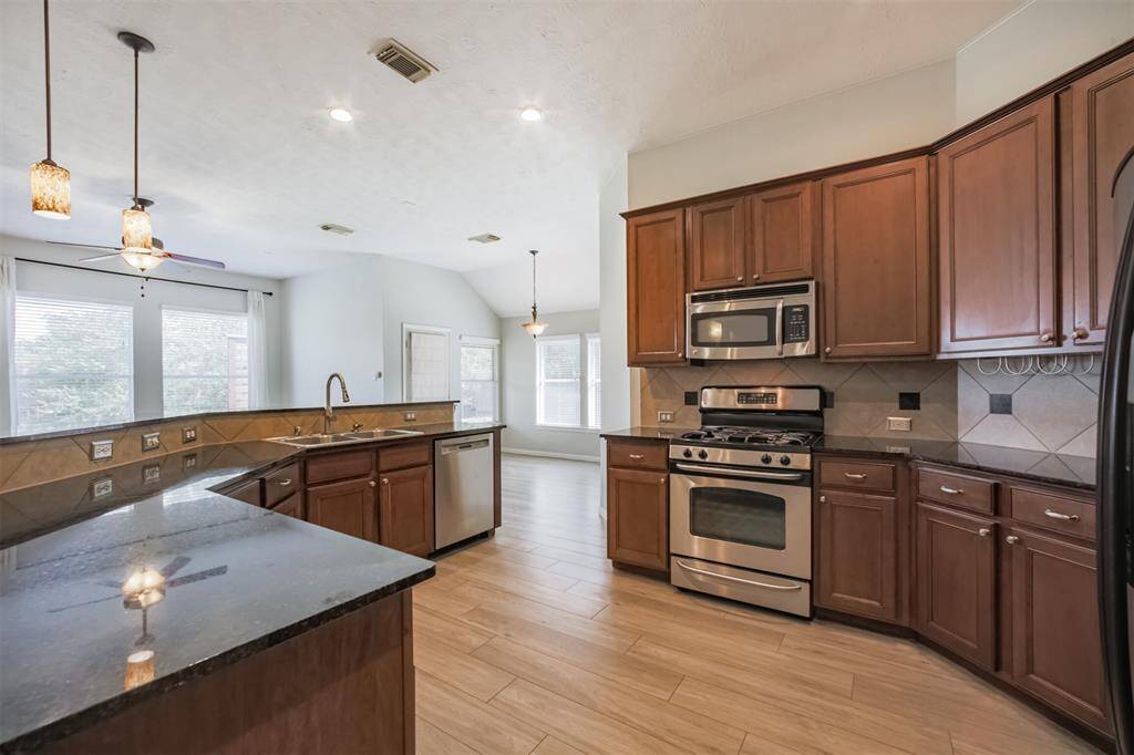 The kitchen offers Ample counterspace and stainless steel appliances.