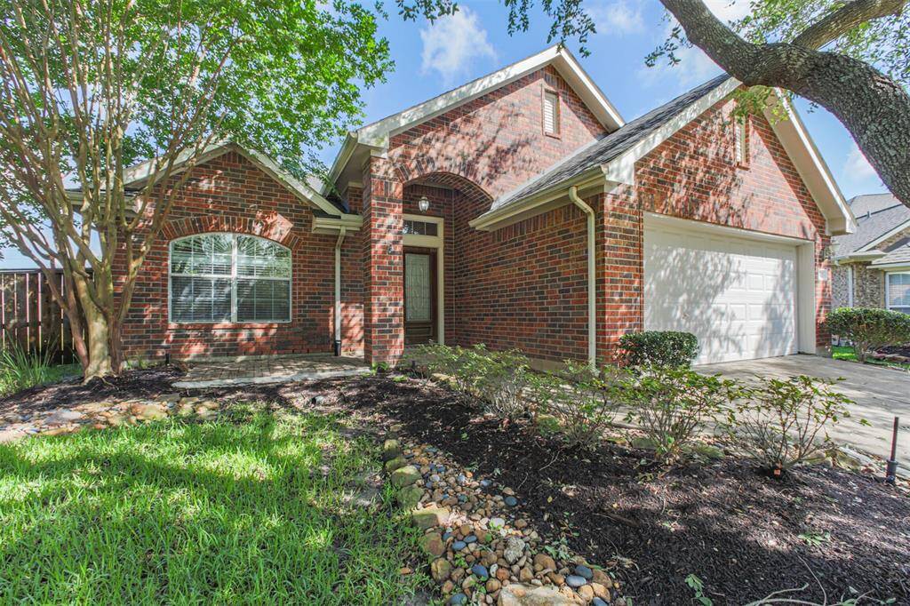 Serene setting with mature trees and vibrant landscaping.