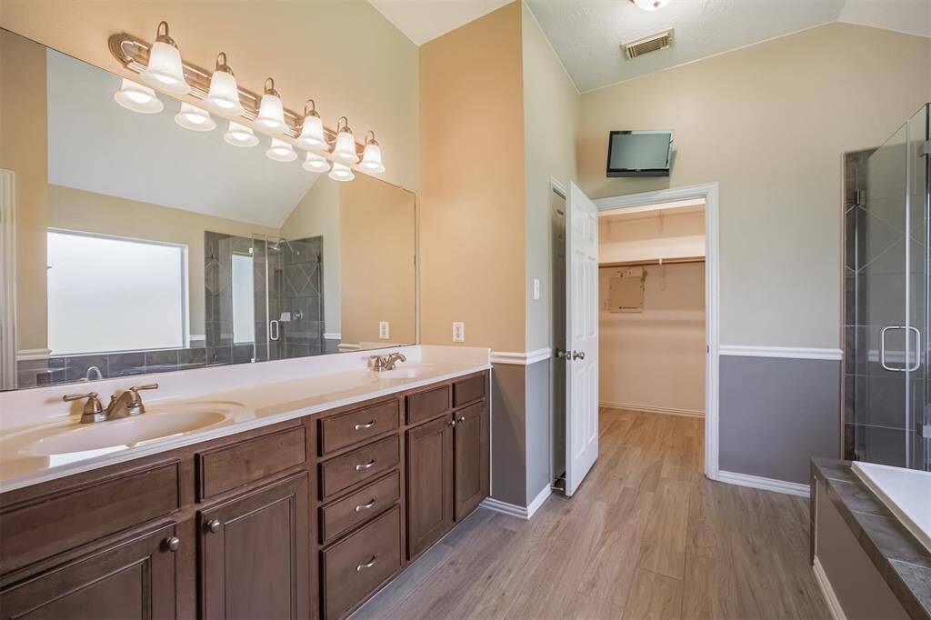 Primary bathroom features double sinks, soaking tub and separate shower.