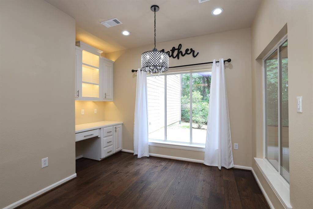 Enjoy the casual dining area that offers the perfect space for everyday meals, complete with a built-in desk ideal for a home management center, homework station, or staying organized with household tasks. A smart and functional addition to this well-designed home.