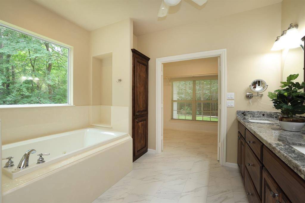 Enjoy a spa-like primary bathroom featuring a relaxing jetted tub, dual sinks, generous storage space, and a private water closet with cabinet. Designed for both comfort and functionality, it’s the perfect place to unwind and refresh.